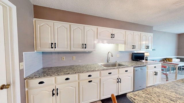103 Yorkshire St, Dothan, AL 36305 - kitchen with stainless steel dishwasher, a textured ceiling, tasteful backsplash, and light stone counters