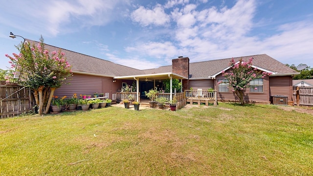 103 Yorkshire St, Dothan, AL 36305 - back of house featuring a fenced backyard, a chimney, and roof with shingles
