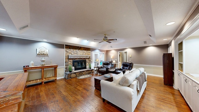 103 Yorkshire St, Dothan, AL 36305 - living room featuring a raised ceiling, wood-type flooring, ceiling fan, a stone fireplace, and recessed lighting