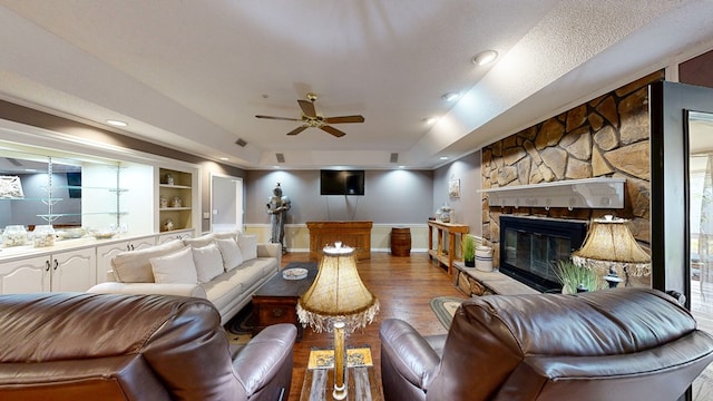 103 Yorkshire St, Dothan, AL 36305 - living room with a ceiling fan, a fireplace, wood finished floors, built in features, and a tray ceiling