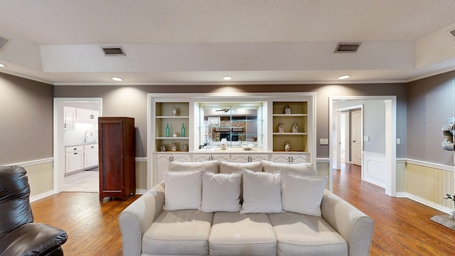103 Yorkshire St, Dothan, AL 36305 - living area featuring wood finished floors, a wainscoted wall, ornamental molding, recessed lighting, and built in features
