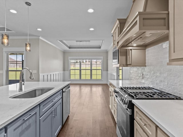 kitchen with range with gas cooktop, a sink, premium range hood, crown molding, and dark wood-style flooring