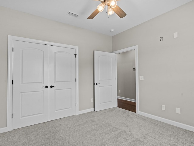 unfurnished bedroom with carpet, baseboards, a closet, and a ceiling fan