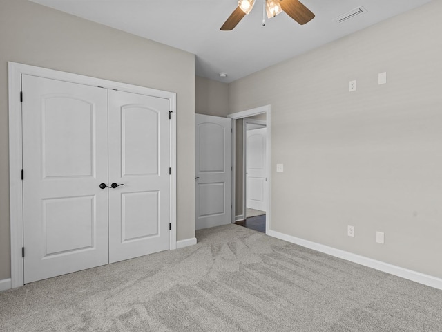 unfurnished bedroom featuring carpet flooring, baseboards, a closet, and ceiling fan