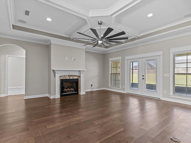 unfurnished living room featuring french doors, coffered ceiling, a ceiling fan, dark wood finished floors, and a fireplace