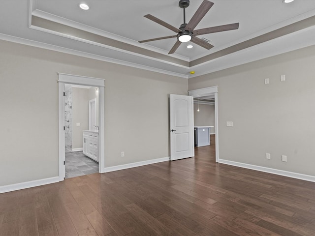unfurnished room with a tray ceiling, ceiling fan, recessed lighting, dark wood finished floors, and crown molding
