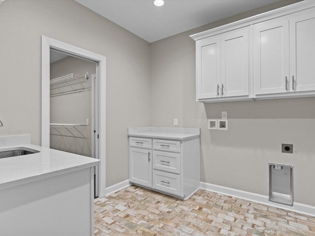 washroom with cabinet space, hookup for an electric dryer, baseboards, hookup for a washing machine, and recessed lighting