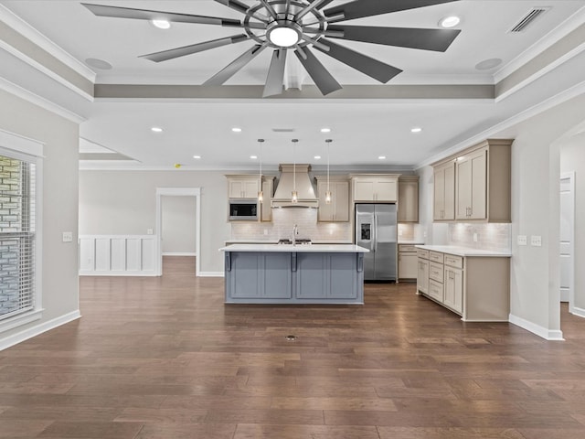 kitchen with stainless steel fridge, premium range hood, built in microwave, light countertops, and ornamental molding