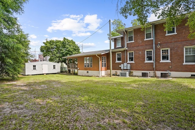 307 S Academy St, Geneva, AL 36340 - rear view of house with central AC, brick siding, and a yard