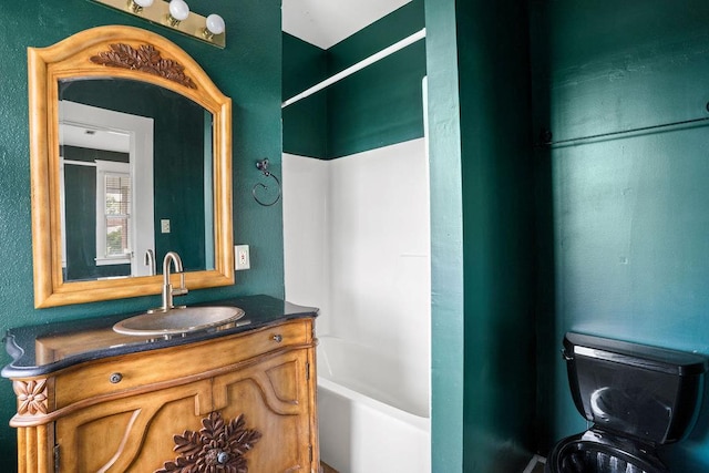 307 S Academy St, Geneva, AL 36340 - bathroom with vanity, washtub / shower combination, and toilet