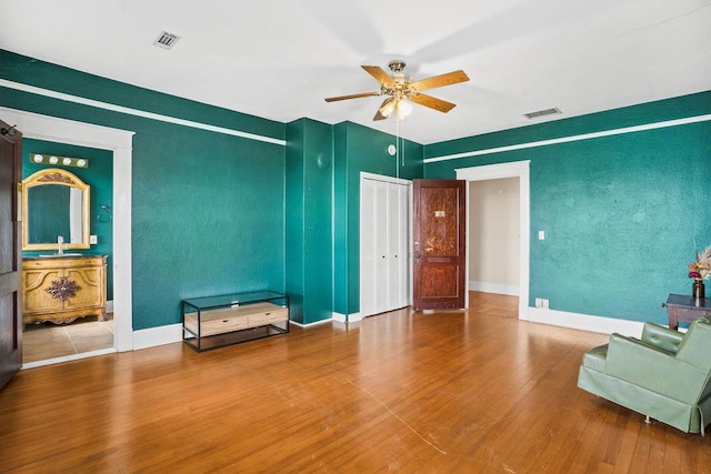 307 S Academy St, Geneva, AL 36340 - living area with a ceiling fan, wood finished floors, and baseboards