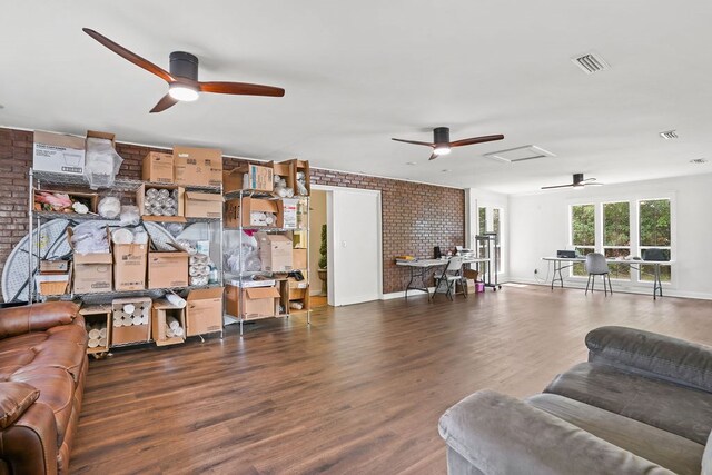 307 S Academy St, Geneva, AL 36340 - living area with a ceiling fan, brick wall, wood finished floors, and baseboards