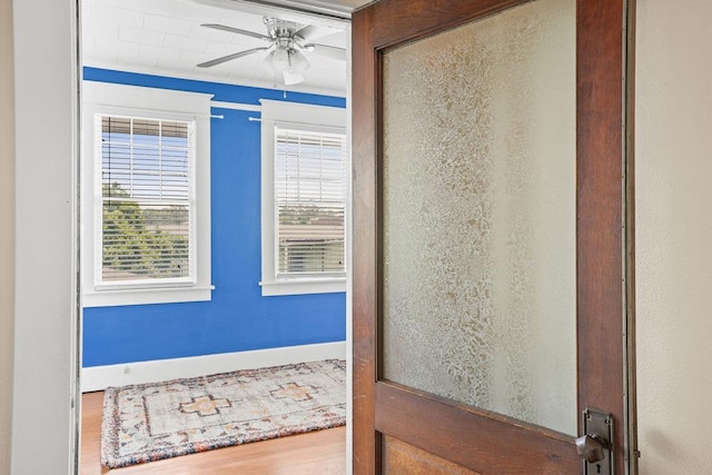 307 S Academy St, Geneva, AL 36340 - doorway to outside with ceiling fan, wood finished floors, and baseboards