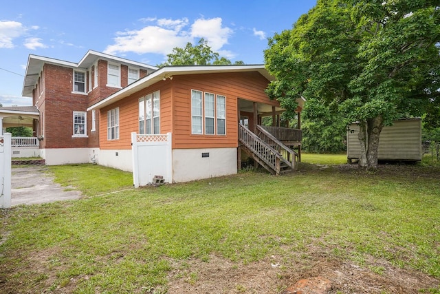 307 S Academy St, Geneva, AL 36340 - rear view of house with crawl space, a lawn, and stairs