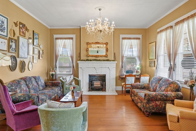 307 S Academy St, Geneva, AL 36340 - living room featuring hardwood / wood-style floors, a chandelier, ornamental molding, and a fireplace
