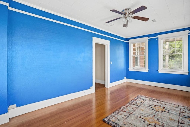 307 S Academy St, Geneva, AL 36340 - empty room with wood finished floors, ceiling fan, crown molding, and baseboards