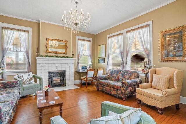 307 S Academy St, Geneva, AL 36340 - living room with hardwood / wood-style floors, a chandelier, ornamental molding, a fireplace, and baseboards