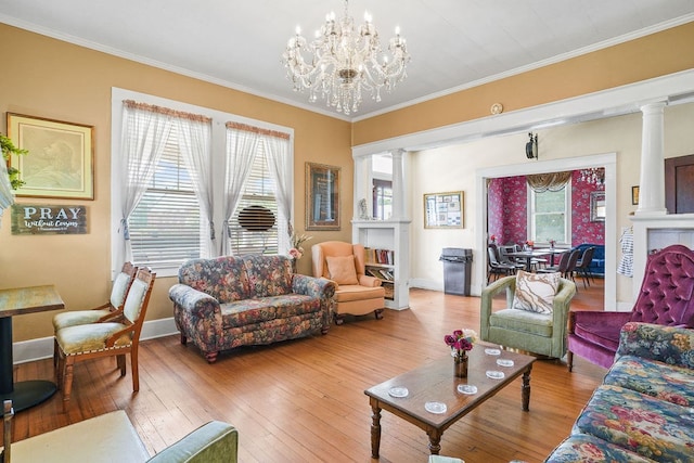 307 S Academy St, Geneva, AL 36340 - living room with decorative columns, wood-type flooring, ornamental molding, and a fireplace