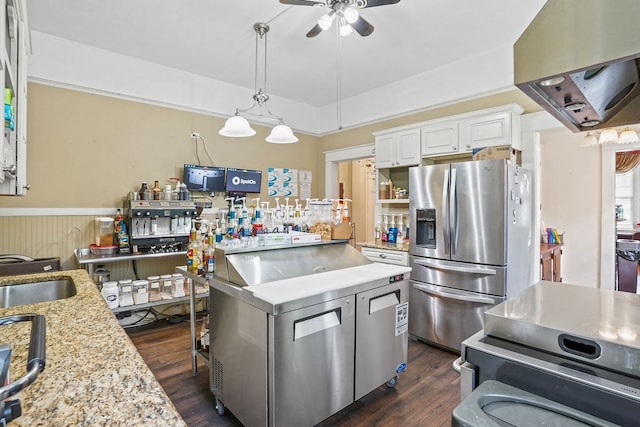 307 S Academy St, Geneva, AL 36340 - kitchen featuring stainless steel refrigerator with ice dispenser, a ceiling fan, white cabinetry, dark wood-style flooring, and a wainscoted wall