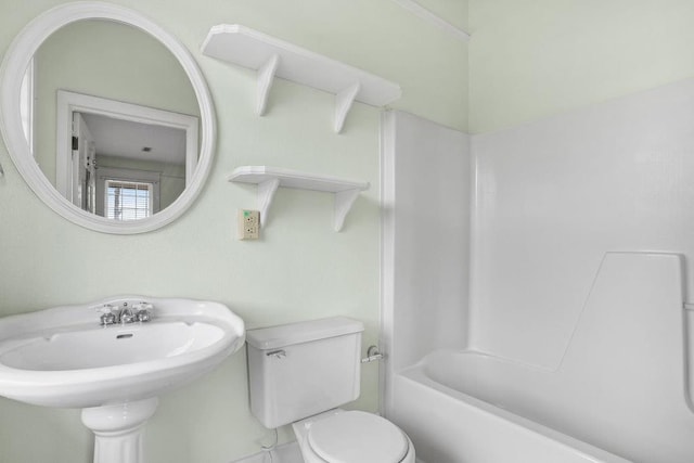 307 S Academy St, Geneva, AL 36340 - bathroom featuring toilet, a sink, and tub / shower combination