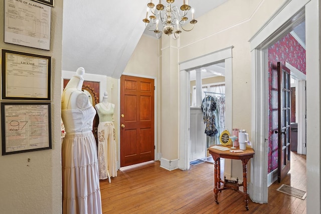 307 S Academy St, Geneva, AL 36340 - foyer featuring a chandelier, hardwood / wood-style floors, vaulted ceiling, and baseboards