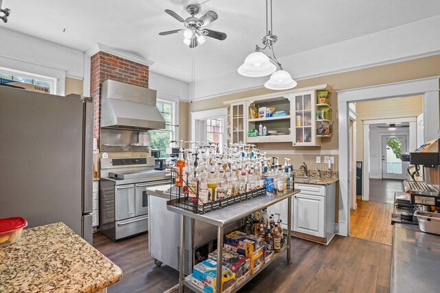 307 S Academy St, Geneva, AL 36340 - kitchen with stainless steel appliances, wall chimney exhaust hood, ceiling fan, open shelves, and dark wood finished floors