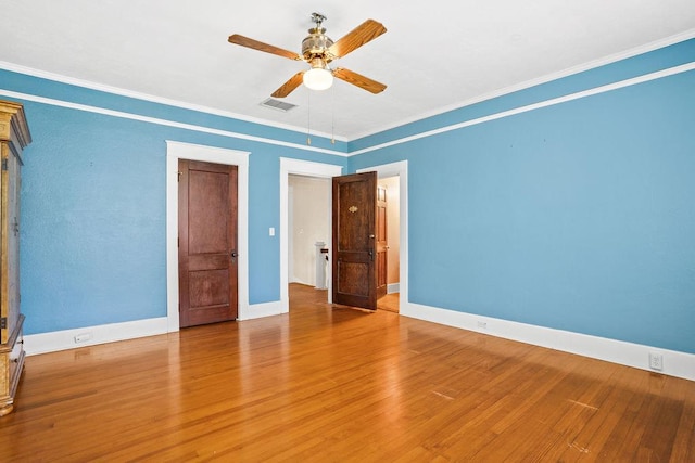 307 S Academy St, Geneva, AL 36340 - unfurnished bedroom featuring wood finished floors, baseboards, ornamental molding, and a ceiling fan