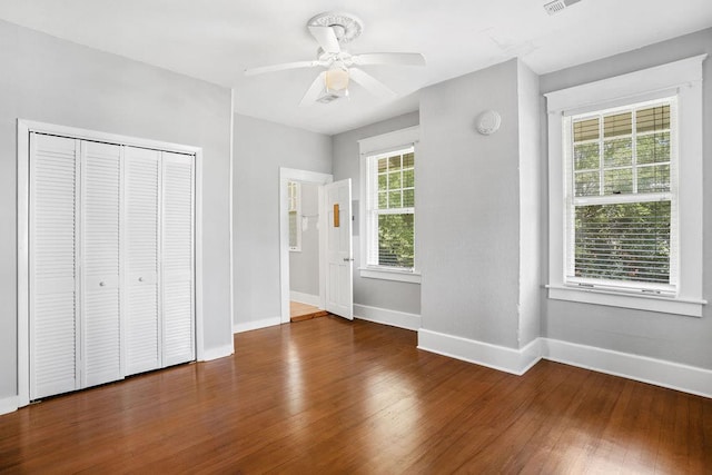307 S Academy St, Geneva, AL 36340 - unfurnished bedroom featuring baseboards, wood finished floors, a closet, and ceiling fan