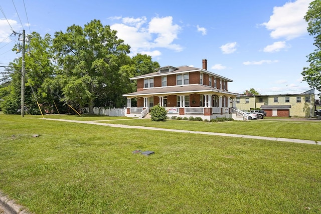 307 S Academy St, Geneva, AL 36340 - view of front of house featuring a porch, a chimney, a front lawn, and brick siding