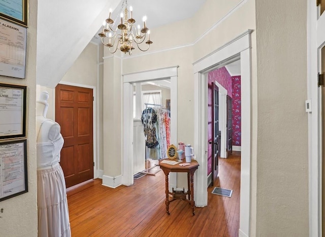 307 S Academy St, Geneva, AL 36340 - entryway with light wood-type flooring, a chandelier, and baseboards