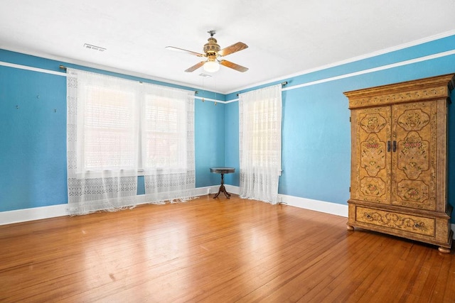 307 S Academy St, Geneva, AL 36340 - unfurnished room with ceiling fan, baseboards, wood-type flooring, and crown molding