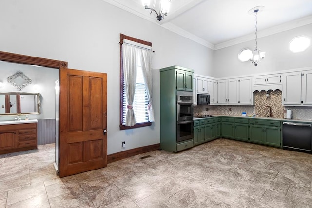 kitchen featuring a high ceiling, green cabinets, hanging light fixtures, appliances with stainless steel finishes, and a notable chandelier