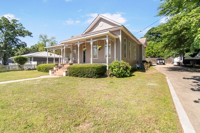 view of front of house with a porch and a front lawn