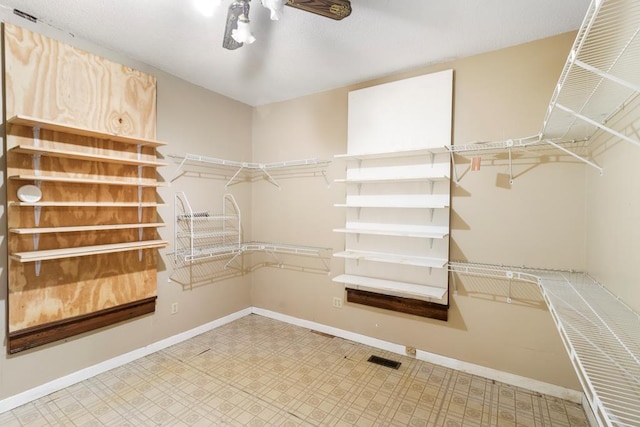 walk in closet featuring ceiling fan