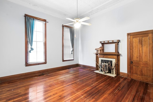 unfurnished living room featuring hardwood / wood-style flooring, plenty of natural light, ceiling fan, and crown molding