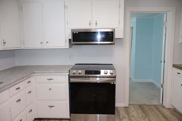 907 E Lee St, Enterprise, AL 36330 - kitchen featuring stainless steel appliances, light wood-style flooring, light countertops, and white cabinets