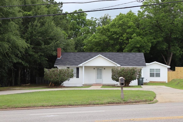 907 E Lee St, Enterprise, AL 36330 - view of front of home featuring concrete driveway, a chimney, and covered porch
