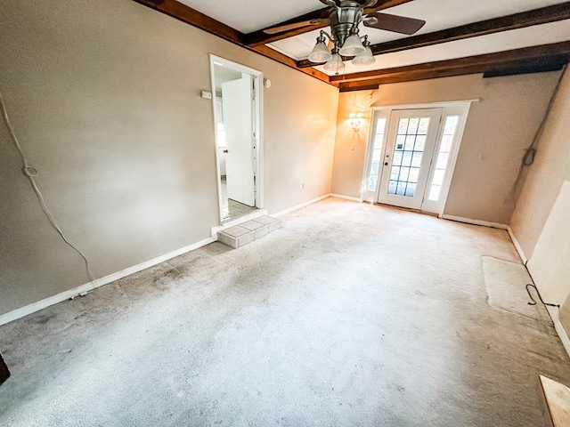 carpeted spare room with beam ceiling, ceiling fan, and ornamental molding