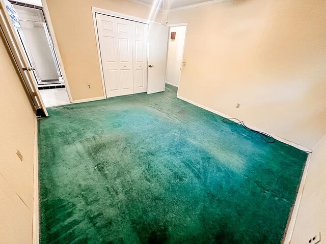 unfurnished bedroom featuring carpet floors and ornamental molding