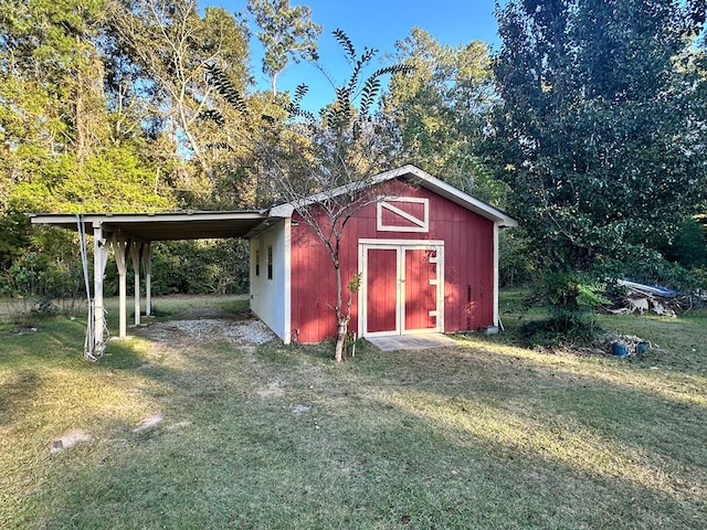 view of outdoor structure featuring a yard and a carport