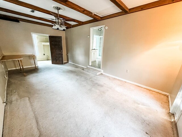 spare room with carpet flooring, ceiling fan, and beam ceiling