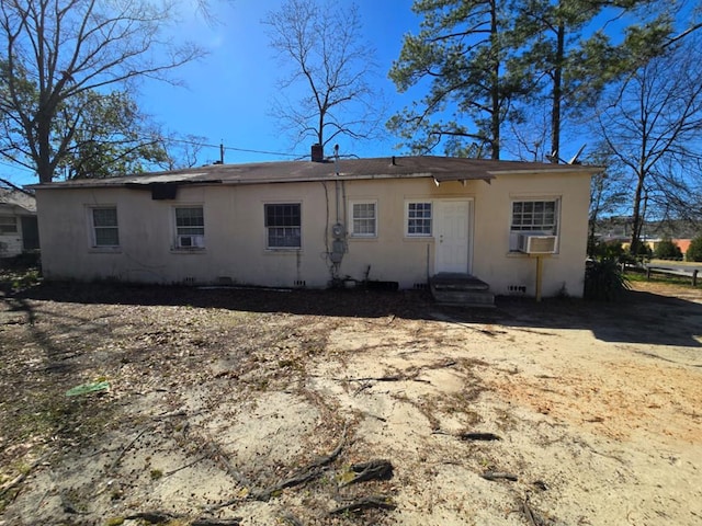 back of property with entry steps and stucco siding