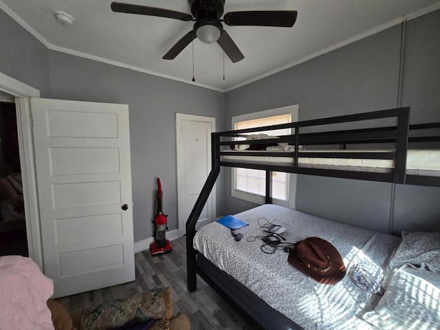 bedroom featuring ornamental molding, a ceiling fan, baseboards, and wood finished floors