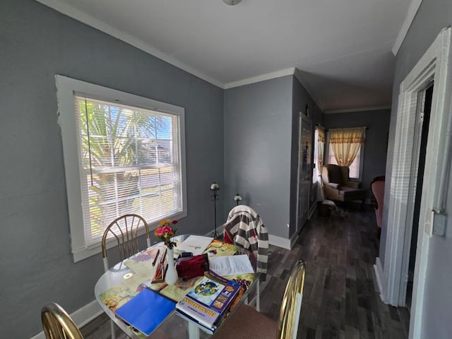 dining space featuring plenty of natural light, ornamental molding, and wood finished floors