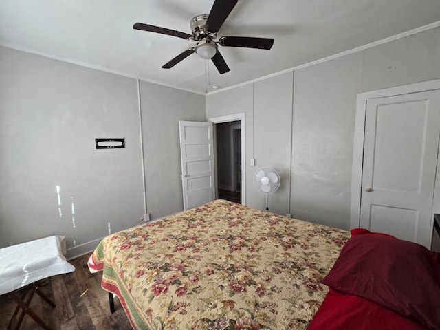 bedroom with ornamental molding, wood finished floors, a ceiling fan, and baseboards