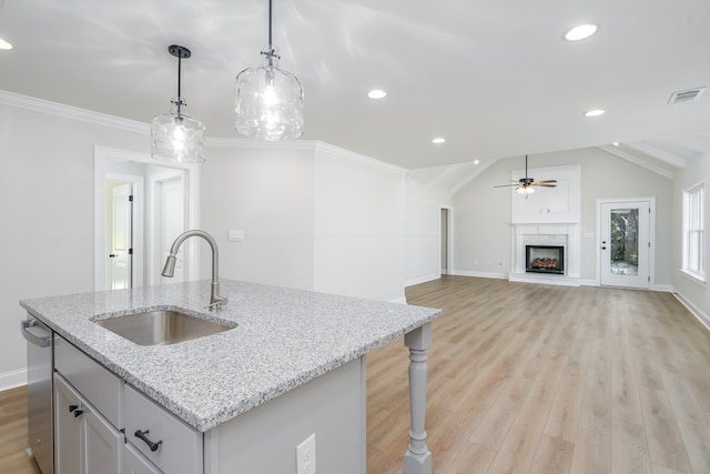 103 Cleo Ct, Enterprise, AL 36330 - kitchen with a ceiling fan, light wood finished floors, a warm lit fireplace, hanging light fixtures, and recessed lighting
