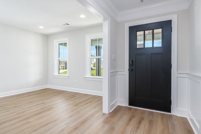103 Cleo Ct, Enterprise, AL 36330 - foyer featuring light wood-style flooring, crown molding, a wainscoted wall, and a decorative wall