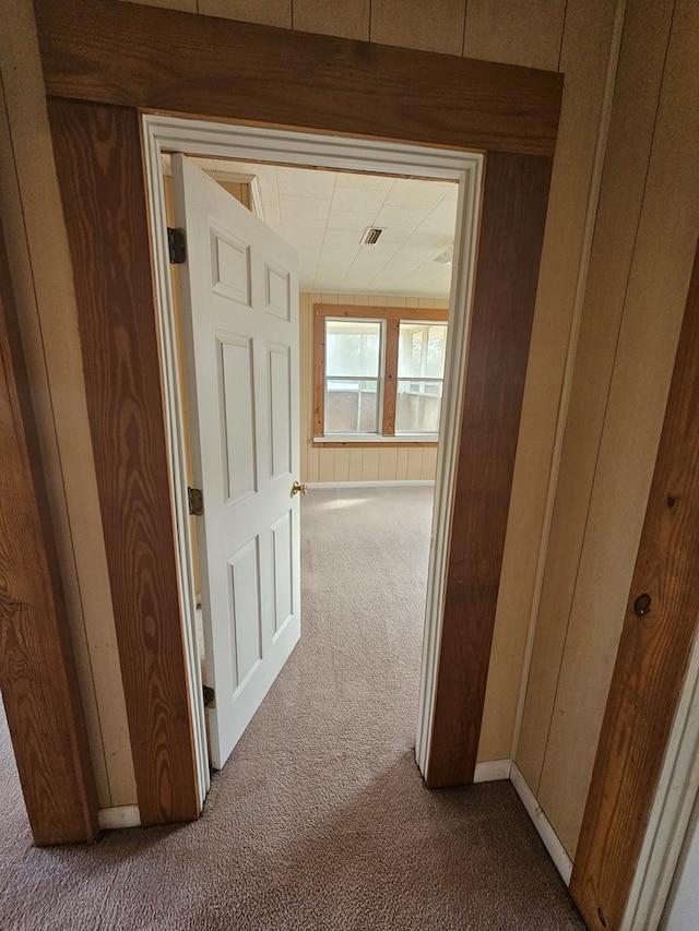 307 Rockhill Cir, Abbeville, AL 36310 - hallway with wooden walls, visible vents, and carpet flooring
