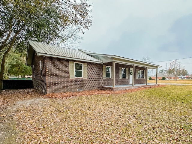 single story home with covered porch and a front lawn