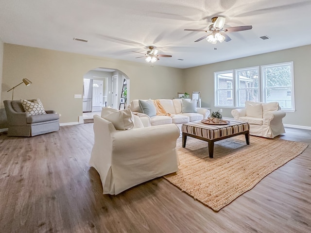 living room with hardwood / wood-style floors and ceiling fan